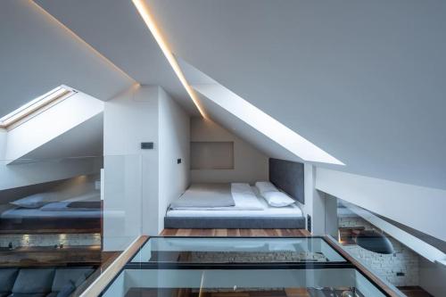 a room with two beds and a glass floor at Contemporary Living in the Heart of the City in Ljubljana