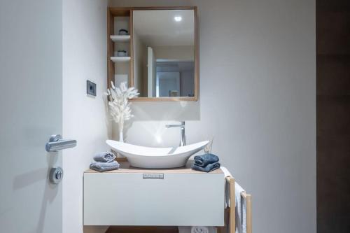 a bathroom with a sink and a mirror at Contemporary Living in the Heart of the City in Ljubljana