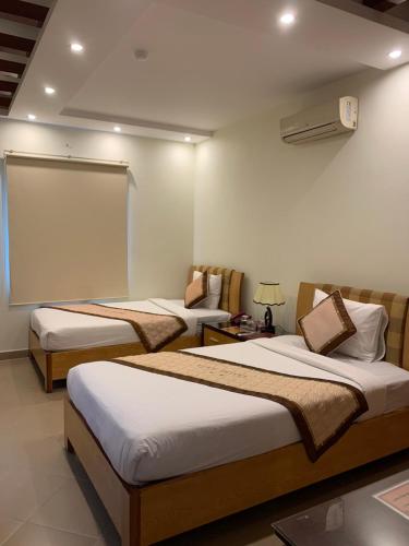 a hotel room with two beds and a window at Hotel Love - 315 Đ. Hoàng Mai - by Bay Luxury in Hanoi
