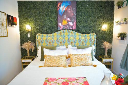 a bedroom with a bed with a white bedspread and a green wall at Garden Oasis in Historic Germantown, Philadelphia in Philadelphia