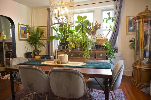 a dining room with a table with chairs and plants at Garden Oasis in Historic Germantown, Philadelphia in Philadelphia