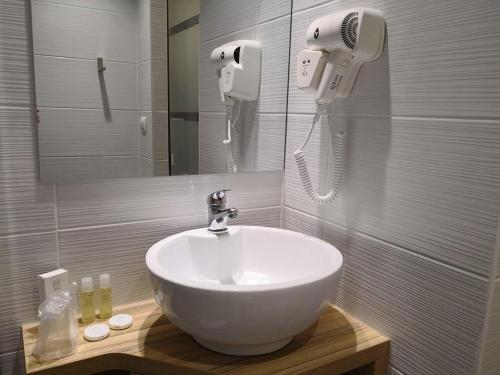 a bathroom with a white sink and a hair dryer at Best Hotel Bordeaux Sud in Villenave-dʼOrnon