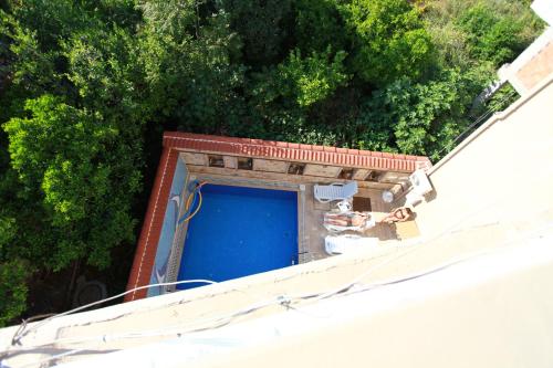 an overhead view of a building with a blue garage at Bacchus Pension in Antalya
