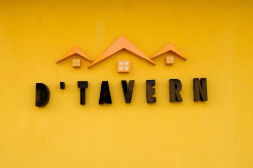 a sign that says durham with houses on a yellow wall at D'Tavern Apartment in Ibadan