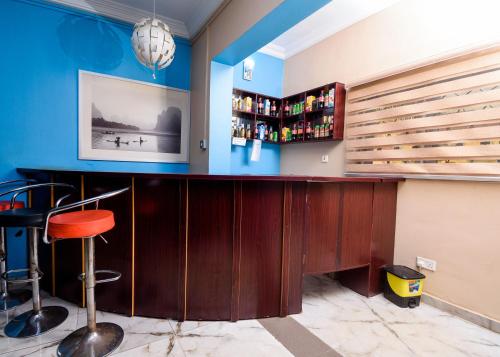 a bar with a red stool in a room at D'Tavern Apartment in Ibadan
