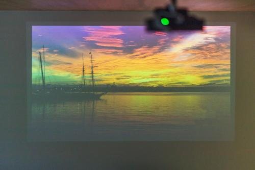 a picture of a sunset with a boat in the water at Takamiya Hotel Jurin in Zao Onsen