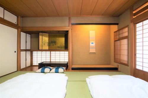 a bedroom with two beds in a room at Arbor house in Kagoshima