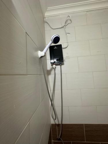 a shower in a bathroom with aphone on the wall at Furnished Studio for rent in Irbid