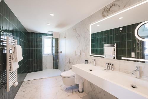 a bathroom with a sink and a toilet and a shower at MADISON Saint Jean de Luz - Handwritten Collection in Saint-Jean-de-Luz