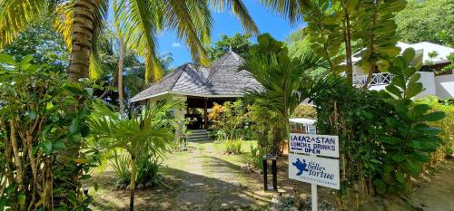a resort with a sign in front of a building at La Belle Tortue in Silhouette Island