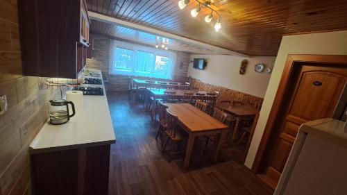 a kitchen with tables and chairs in a restaurant at Privát Nataša in Nová Lesná