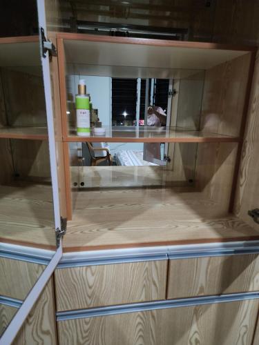 a wooden cabinet with a window in a room at Lot 10 Hasmat Road in Nausori