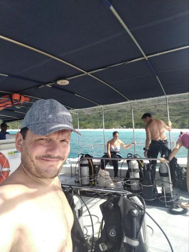 a man wearing a hat on a boat at La Belle Tortue in Silhouette Island
