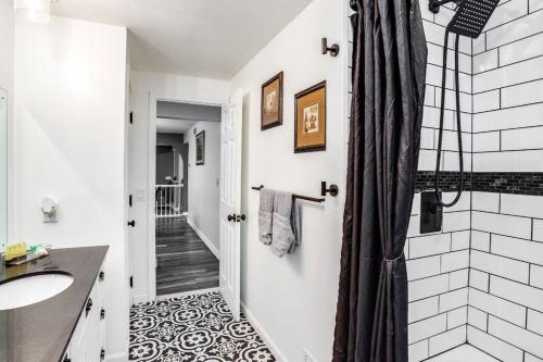 a bathroom with a shower and a sink at Fantastic Home Near DWTN/Airport in Rochester