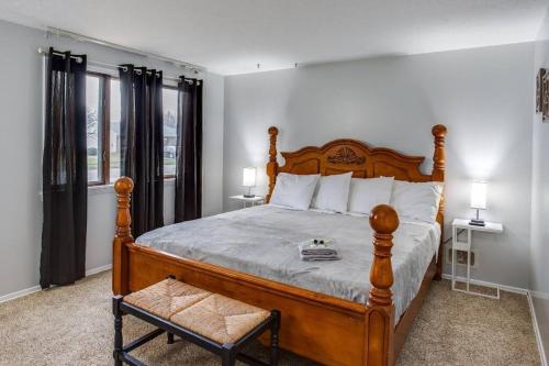 a bedroom with a large bed with a wooden frame at Fantastic Home Near DWTN/Airport in Rochester