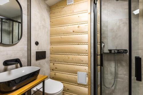 a bathroom with a sink and a shower at Apartament Tatry Centrum in Zakopane