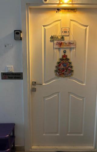 a white door with a christmas ornament on it at LausDeo1 self checkin 2BHK AC corner flat top floor in Trivandrum