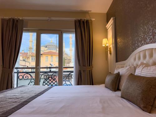 a bedroom with a bed with a view of the city at Sarnic Premier Hotel in Istanbul