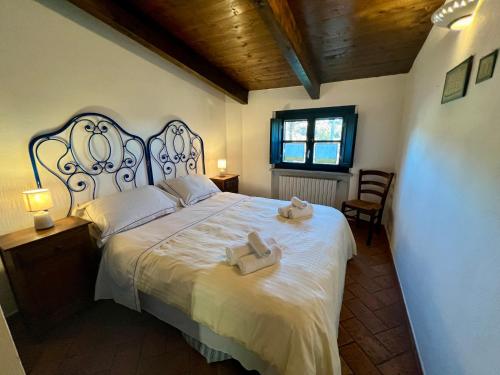 a bedroom with a large bed with two towels on it at Le Serre Suites & Apartments in Moncalieri