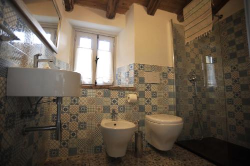a bathroom with a sink and a toilet and a window at Agriturismo La Contessa in Finale Ligure