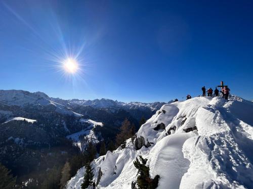 a group of people standing on top of a snow covered mountain at Auf'm Feggenlehen in Ramsau