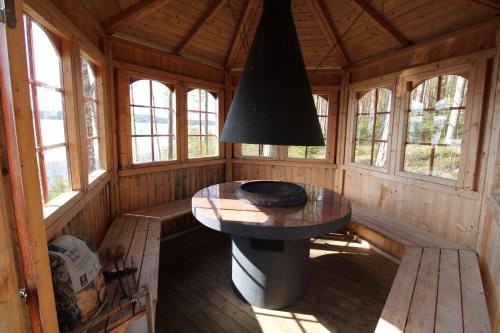a dining room in a wooden cabin with a table at Villa Nurminiemi in Koro
