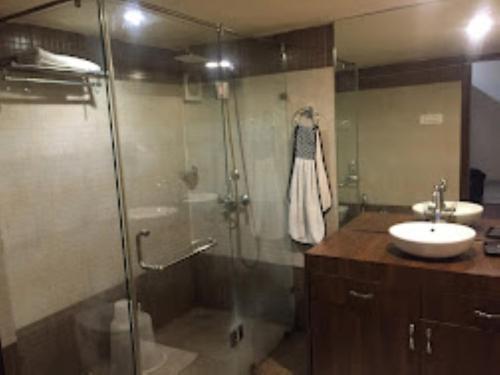 a bathroom with a shower and a sink at Hotel Saroj Sagar Madhya Pradesh in Sāgar