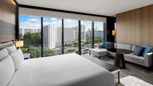 a hotel room with a bed and a large window at InterContinental Singapore Robertson Quay by IHG in Singapore