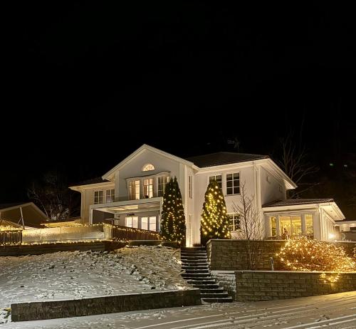 a white house with christmas lights in front of it at Hills Cottage in Gränna