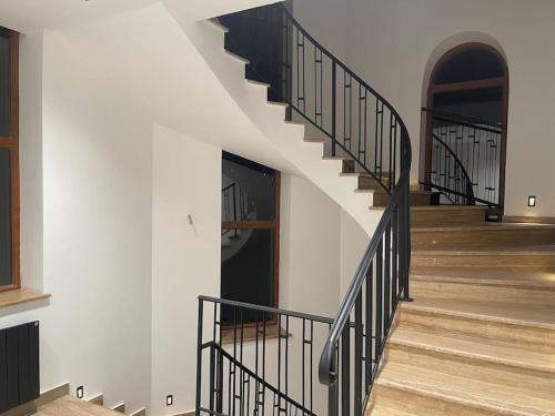 a staircase with black railings in a building at Fabulous Villa In Yerevan. in Yerevan