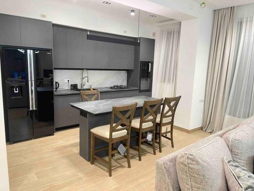 a kitchen with a table and chairs in a room at Fabulous Villa In Yerevan. in Yerevan