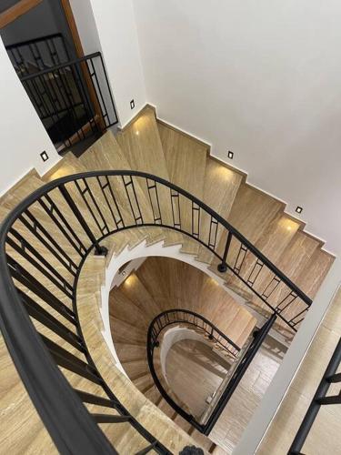 a spiral staircase in a building with people walking down it at Fabulous Villa In Yerevan. in Yerevan