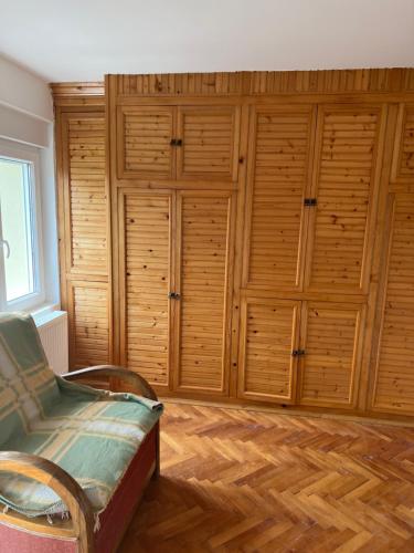 a room with wooden cabinets and a bed in it at Vila Vera in Divčibare