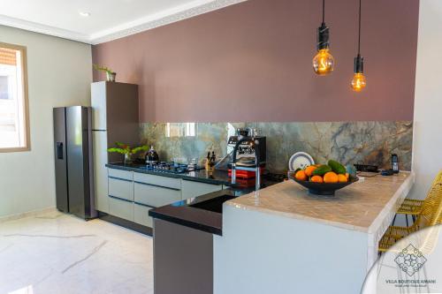 a kitchen with a bowl of fruit on a counter at Villa Boutique Amani in Marrakech