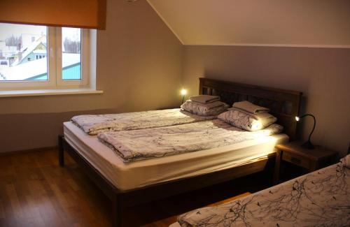 a bedroom with two beds and a window at Raja Lake House in Raja