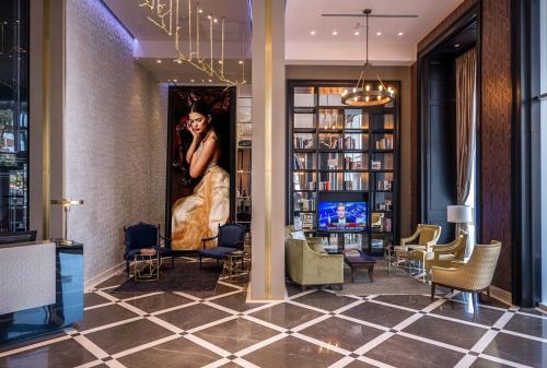 a lobby with a painting of a woman on the wall at David Tower Hotel Netanya by Prima Hotels - 16 Plus in Netanya