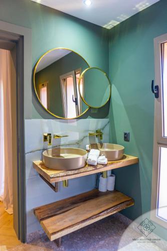 a bathroom with two sinks and a large mirror at Villa Boutique Amani in Marrakech