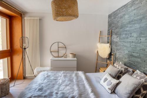 a bedroom with a large bed and a mirror at L'AvantGardiste, Spacious 6 bedrooms duplex, panoramic view in Crans-Montana