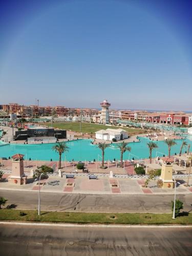 a large pool of blue water with palm trees and buildings at Sharm El Sheikh Home & Studios in Sharm El Sheikh