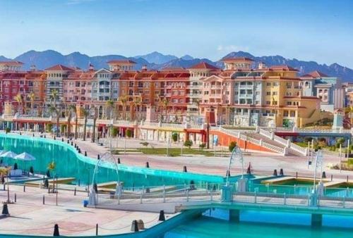 a resort with a swimming pool and some buildings at Sharm El Sheikh Home & Studios in Sharm El Sheikh