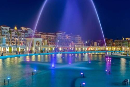 a large fountain in the middle of a city at night at Sharm El Sheikh Home & Studios in Sharm El Sheikh