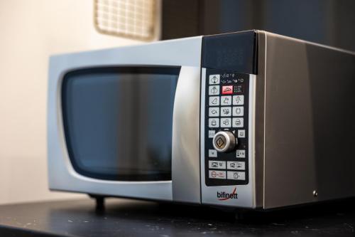 a microwave oven sitting on top of a table at Apartamenty PREMIUM, Faktura VAT, Źródłowa CENTRUM PARTER GROUND FLOOR PARKING SUPER LOKALIZACJA TWO BEDROOMS KITCHEN 50 M2 in Kielce