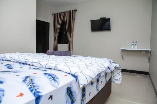 Ένα ή περισσότερα κρεβάτια σε δωμάτιο στο Saba Ayu Guest House