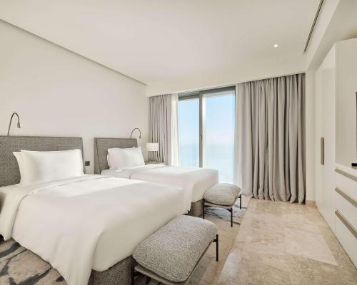 a hotel room with two beds and a window at Grand Hyatt Kuwait Residences in Kuwait