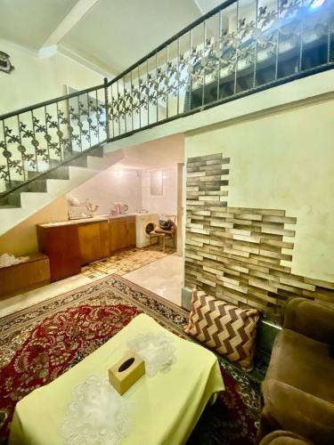 a room with a staircase and a living room at Maria Hostel in Yerevan