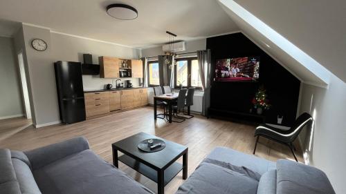 a living room with a couch and a table at Apartamenty Czarna Perła in Kowary