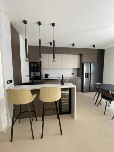 a kitchen with two chairs and a counter in a room at Luxury apartment with jacuzzi in Podstrana
