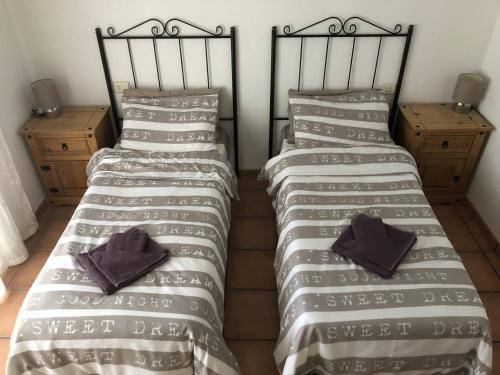 two twin beds sitting next to each other in a room at Puerto de Mazarrón - Large 2 or 3 Bedroom House with Roof Terrace and Wonderful Sea Views in Puerto de Mazarrón