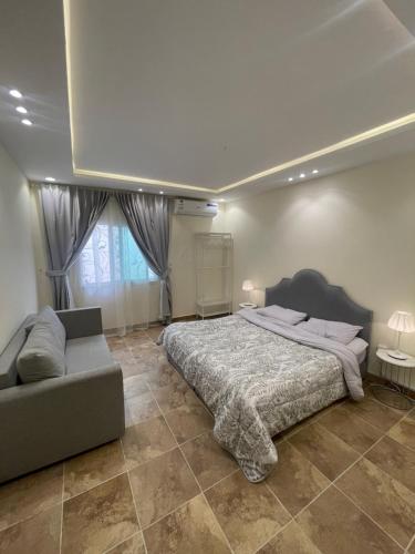a bedroom with a large bed and a couch at ماكس الفندقية 15 in Riyadh