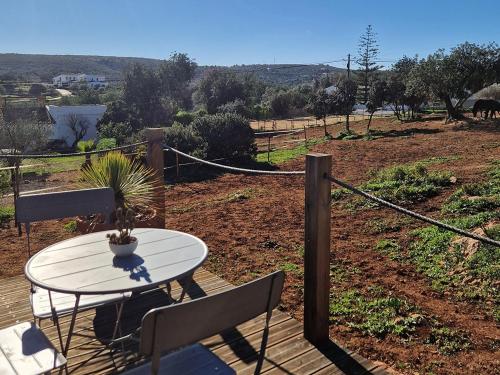 a table and two chairs on a wooden deck at Tiny House Loul Algarve no1 in Loulé